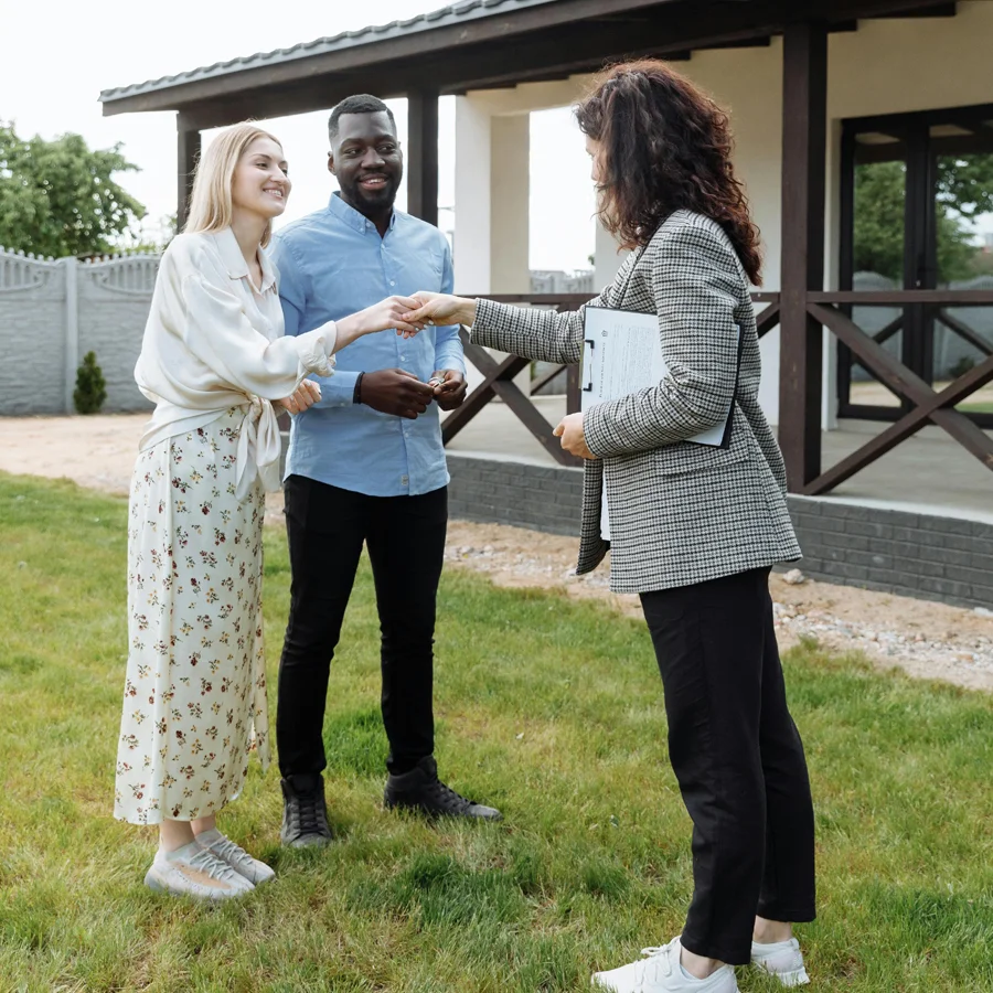 Appraiser shaking hands with the homeowners after reviewing the real estate appraisal services