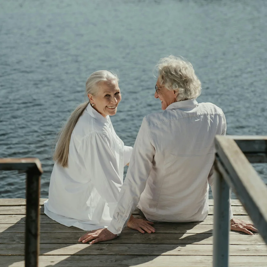 A senior couple sitting at the end of a pier enjoying the view, representing who we serve for appraisals