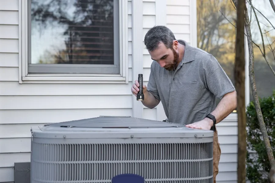 An appraiser performing a home appraisal inspection on the HVAC