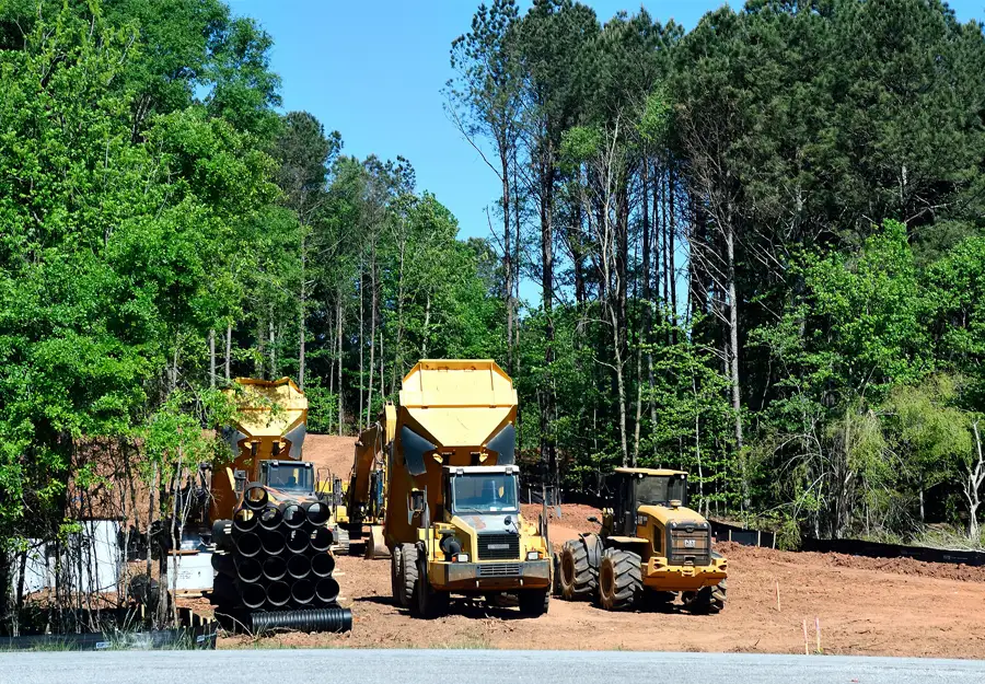 Trucks clearing out land after a land appraisal